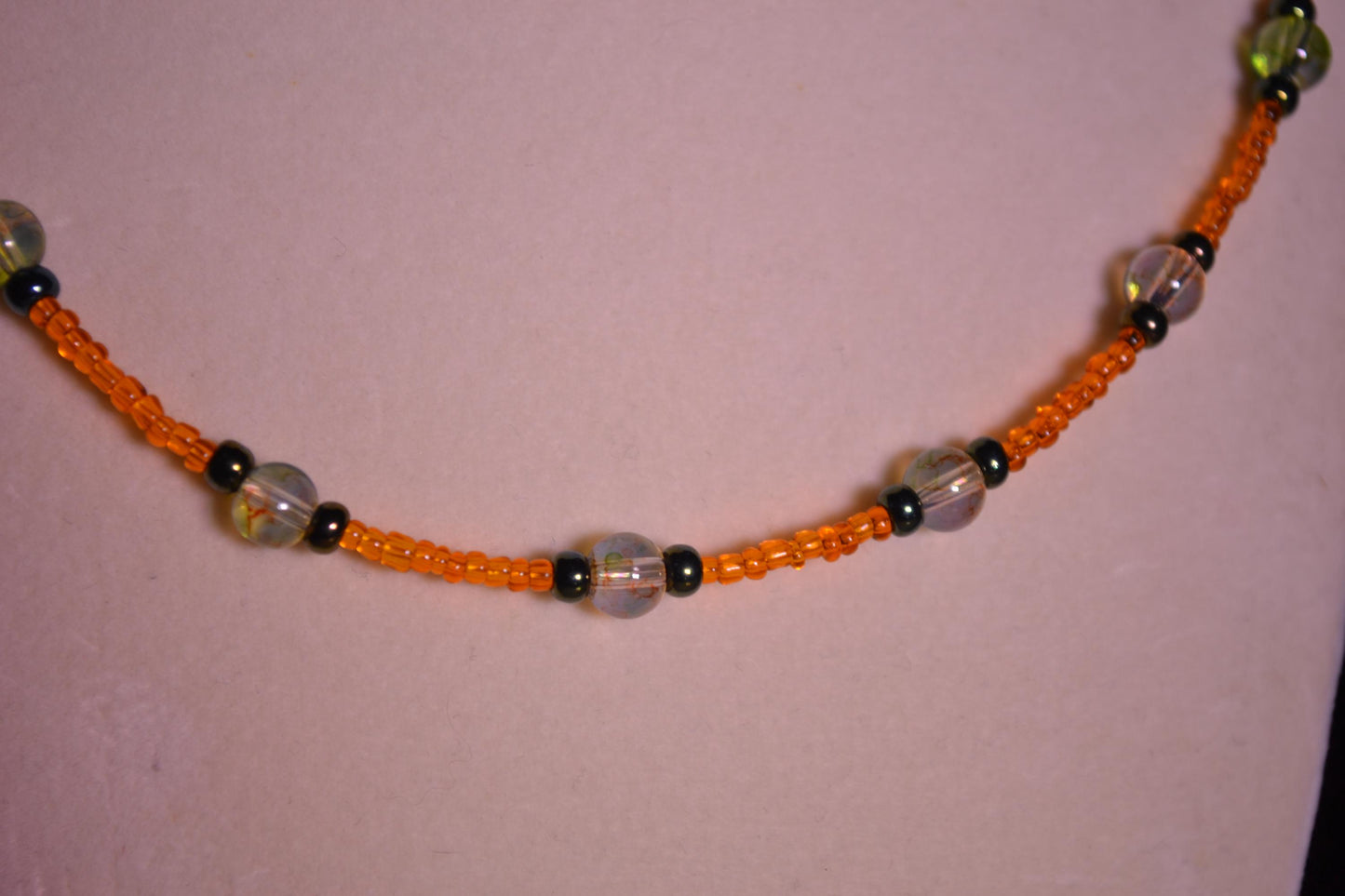 Multicolor glass bead necklace. Orange, black, and topaz.